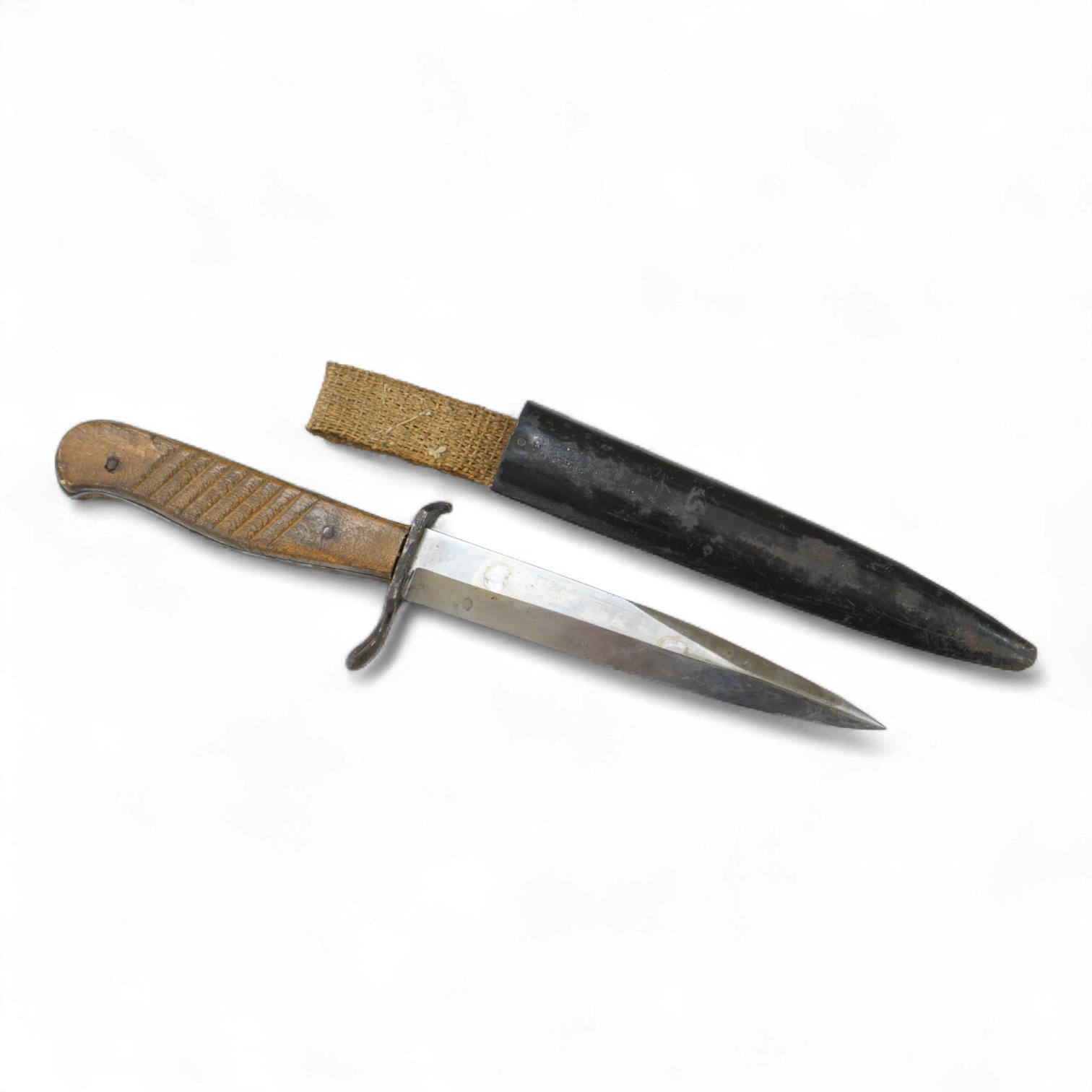 A First World War German Fighting Knife, with two piece wooden grip and steel cross guard, in original steel scabbard with canvas belt loop mount, single edged unmarked blade, blade 14cm, overall 25.5cm.